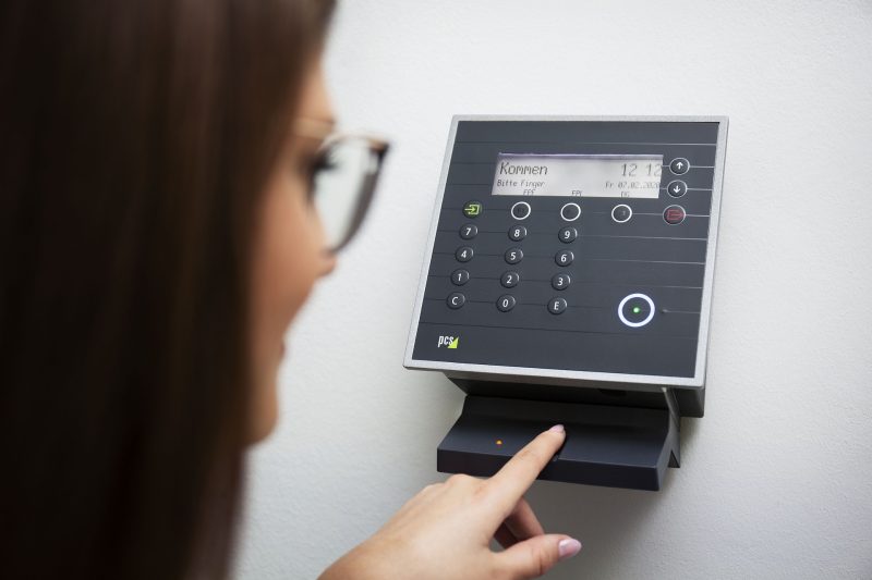 an employee accessing biometric attendance management system